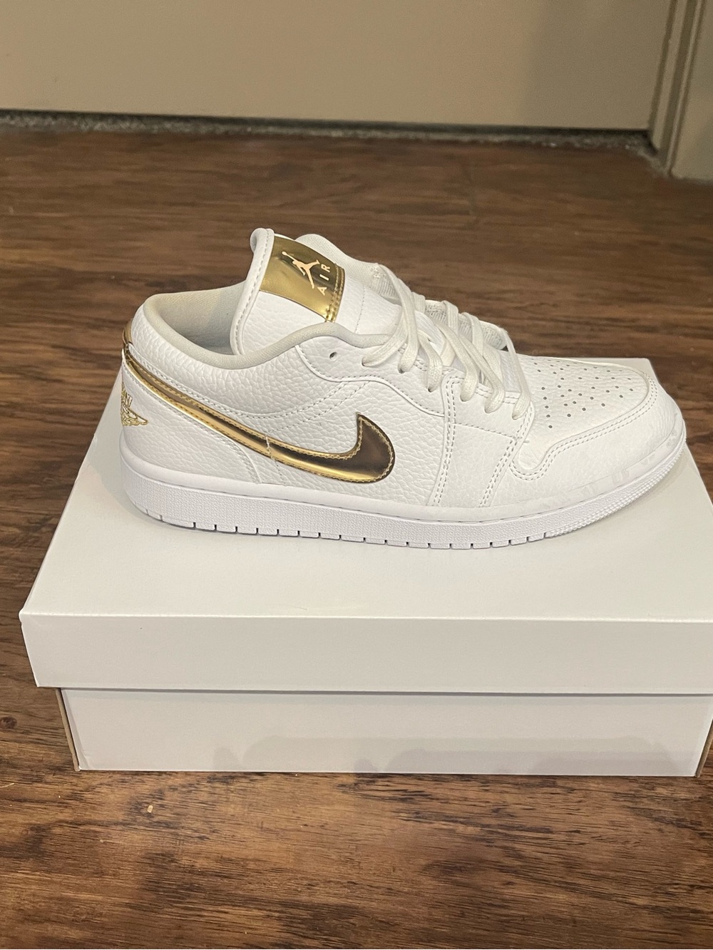 Nike Jordan Air Jordan 1 White Low Sneaker with Gold Accents